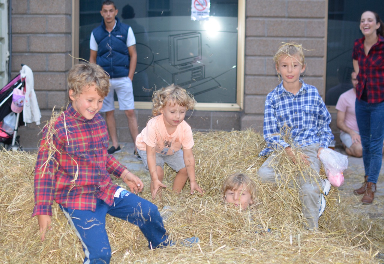 Kids play in hay at the Hackett hoedown