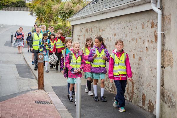 Transport Minister hops on 'walking bus' to school