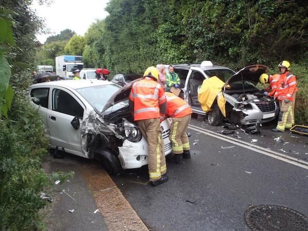 Woman taken to hospital and man trapped in car after rush hour crash